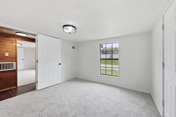 an empty room with windows and closet