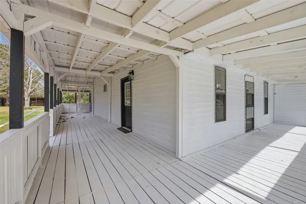 a view of a porch with wooden floor
