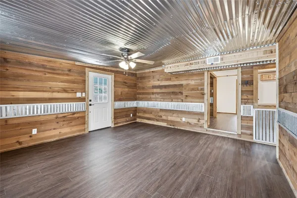 a view of a room with wooden floors