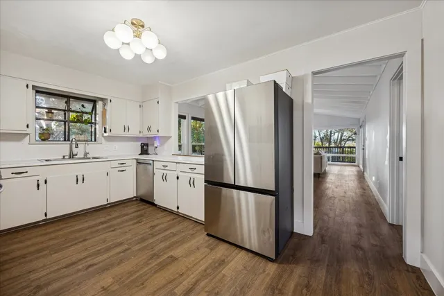 a kitchen with stainless steel appliances a refrigerator sink and cabinets