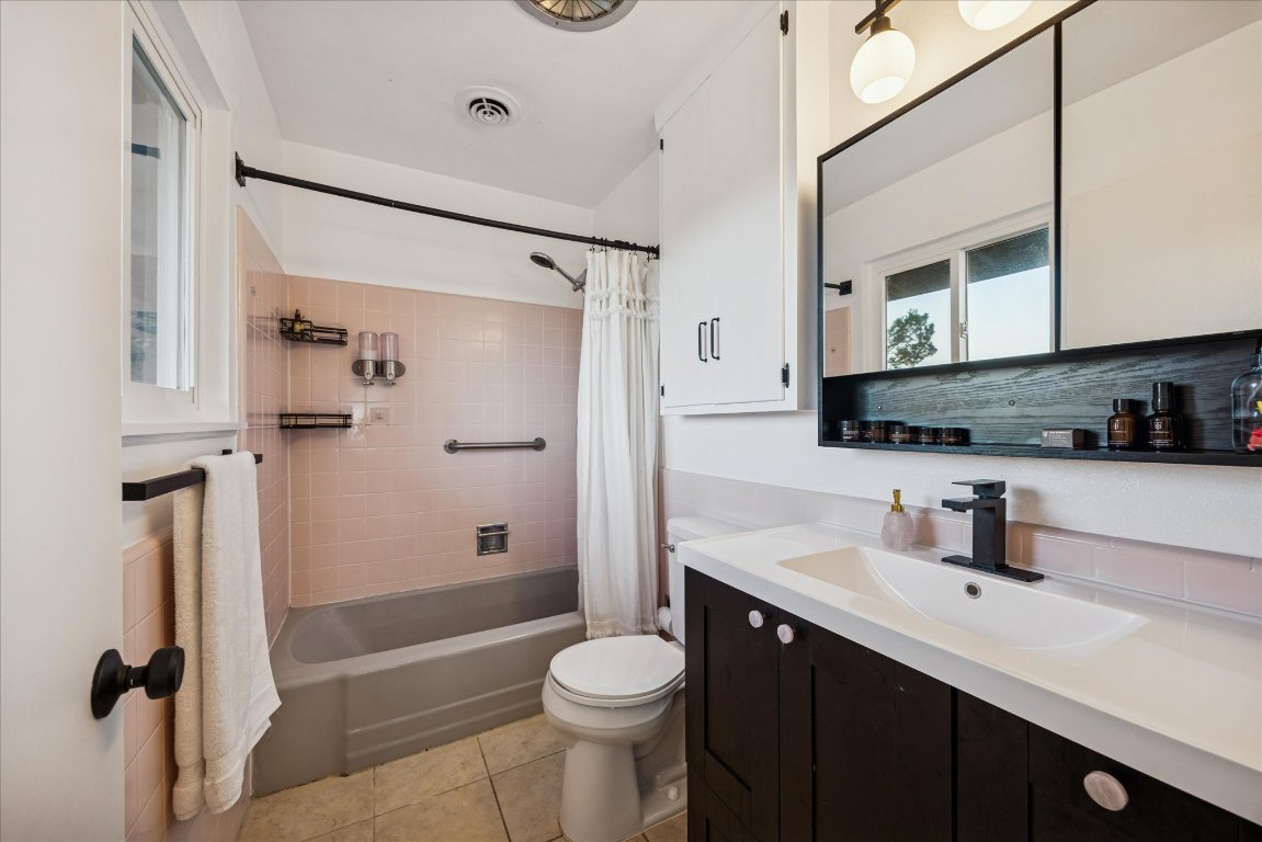 6407 Lynn Lane Lago Vista, TX 78645 - Photo 14 of 32 a bathroom with a sink a toilet and shower