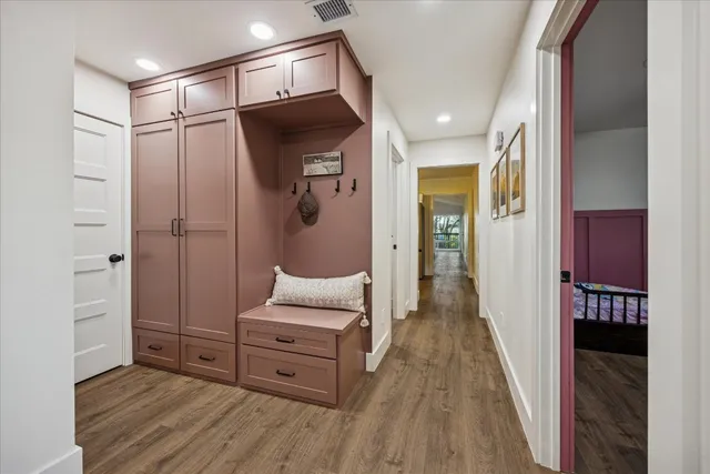 a room with wooden floor and furniture