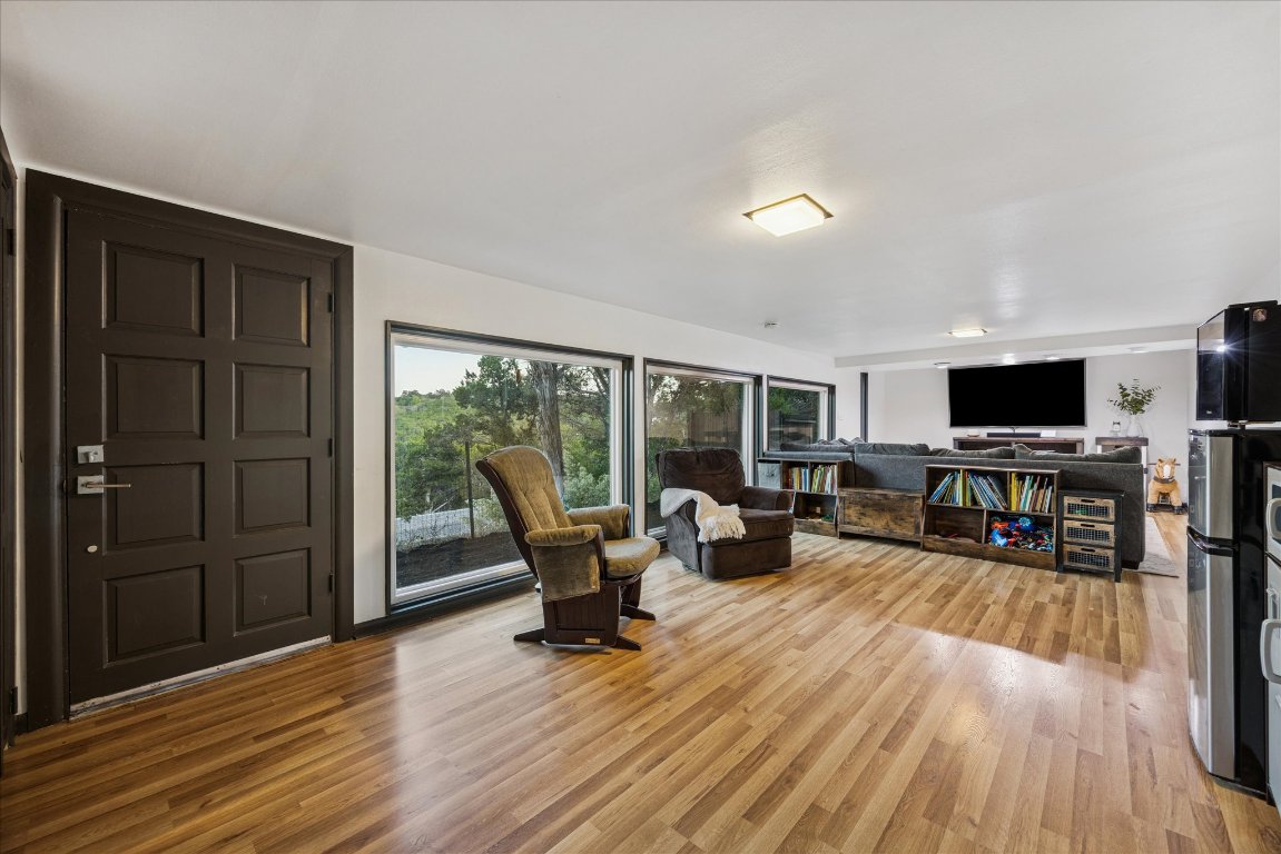 6407 Lynn Lane Lago Vista, TX 78645 - Photo 20 of 32 a living room with furniture and a flat screen tv