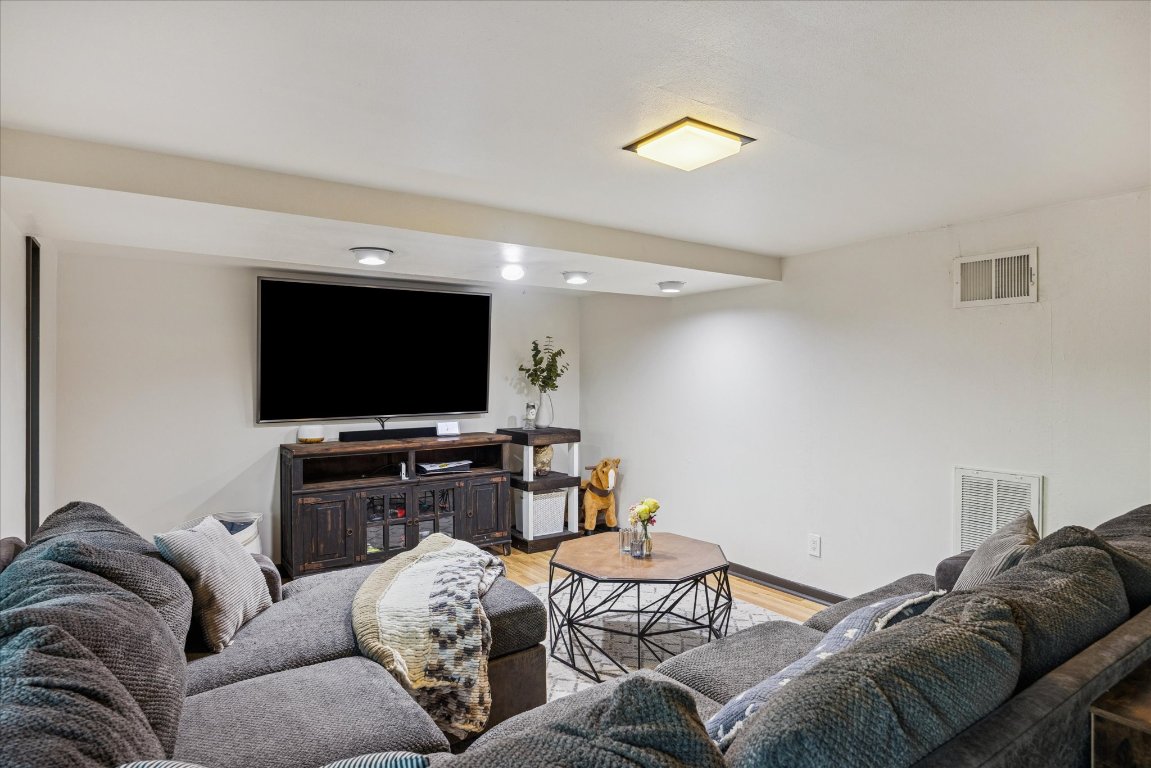 6407 Lynn Lane Lago Vista, TX 78645 - Photo 22 of 32 a living room with furniture and a flat screen tv