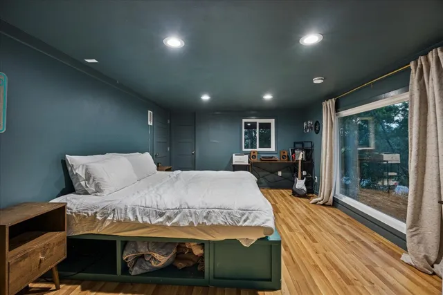 a bed room with a bed and a large window