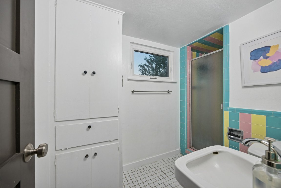 6407 Lynn Lane Lago Vista, TX 78645 - Photo 26 of 32 a bathroom with a sink and a mirror