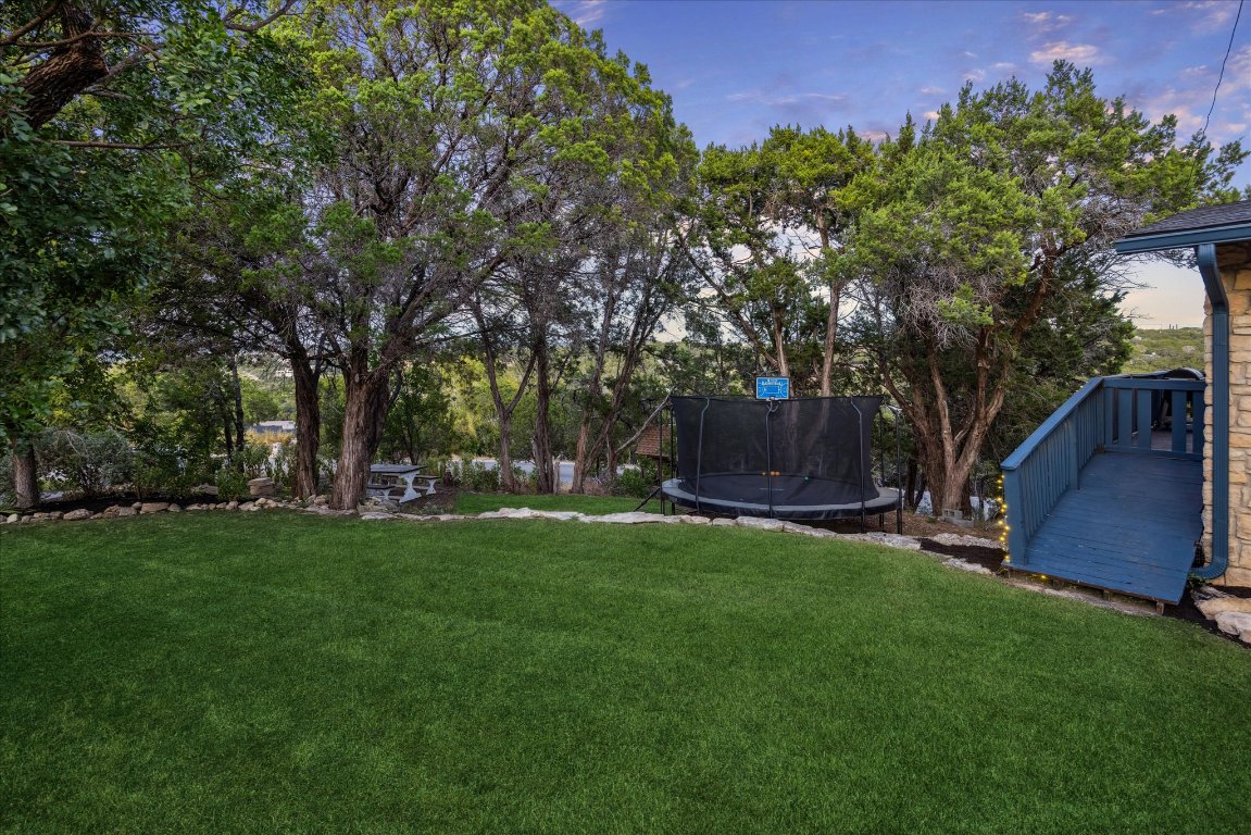 6407 Lynn Lane Lago Vista, TX 78645 - Photo 29 of 32 a backyard of a house with table and chairs