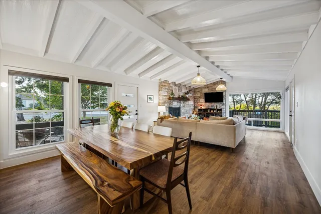 a dining room with furniture and wooden floor