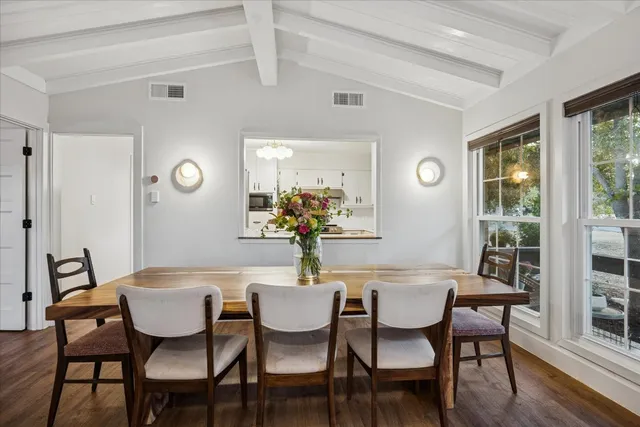 a dining room with furniture and window