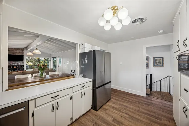 a kitchen with stainless steel appliances granite countertop a refrigerator and a stove top oven