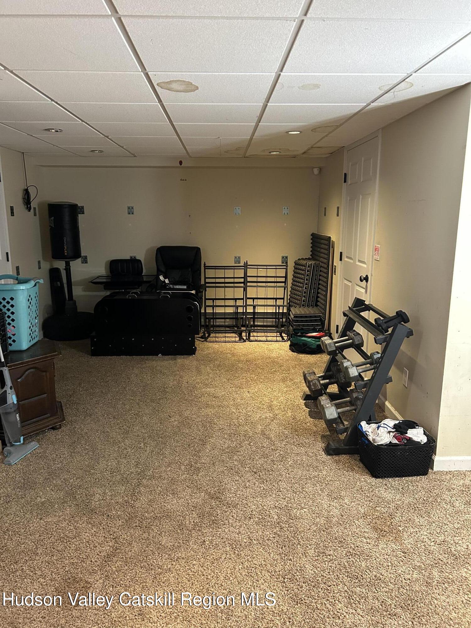 229 Cold Spring Road Hudson, NY 12534 - Photo 11 of 14 a bed room with furniture and a gym machine