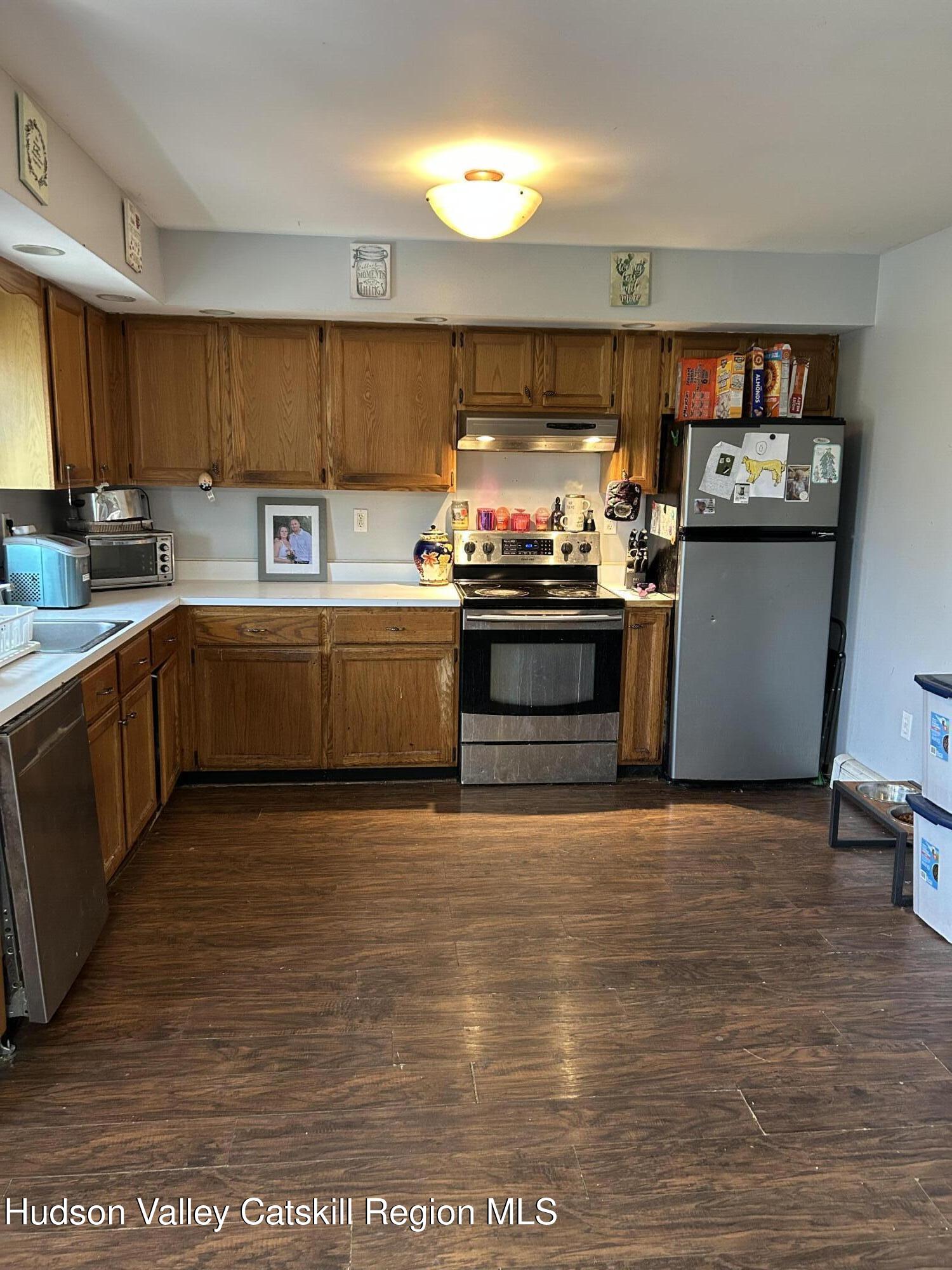 229 Cold Spring Road Hudson, NY 12534 - Photo 5 of 14 a kitchen with stainless steel appliances granite countertop a stove a sink and a microwave