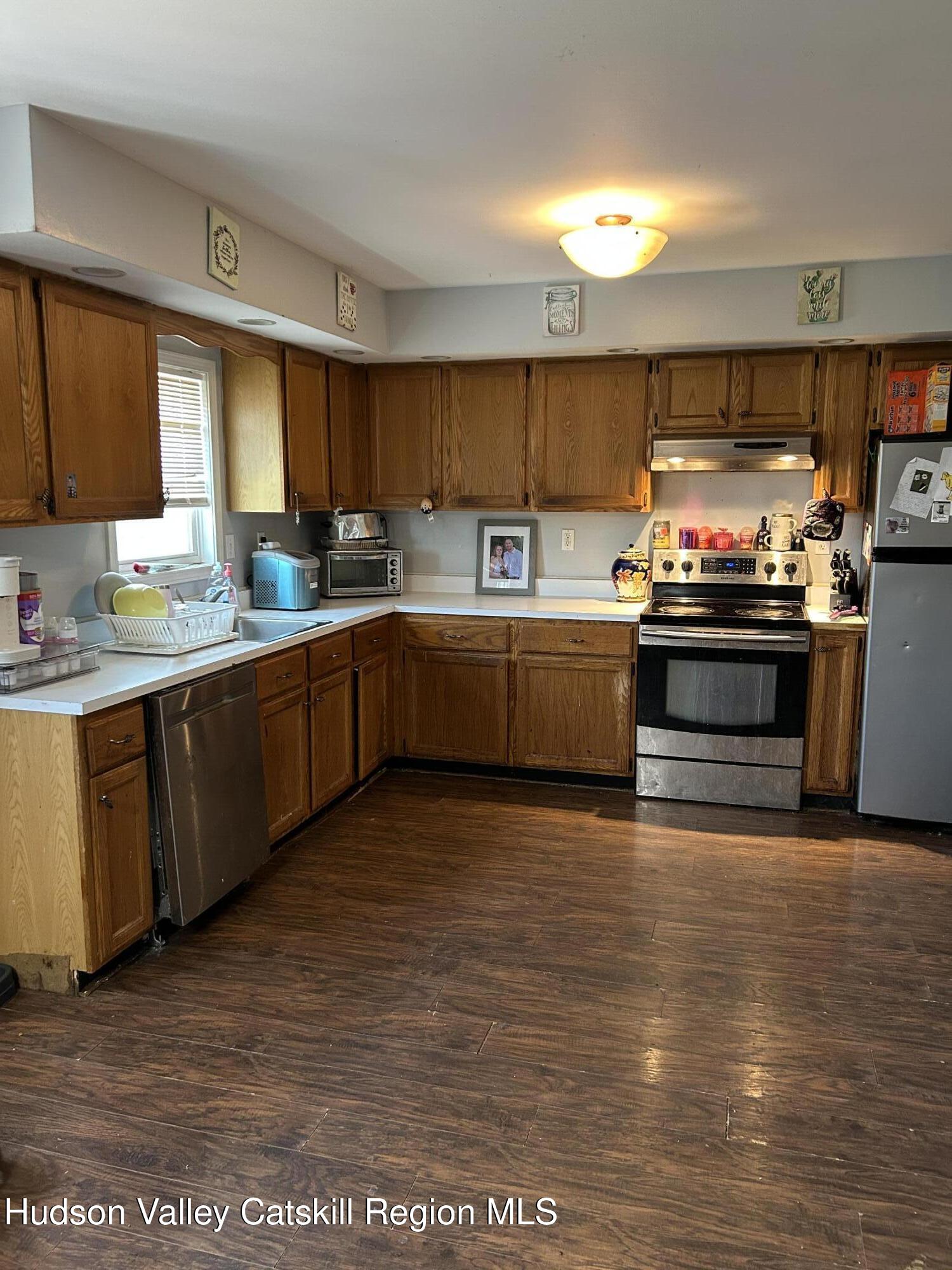 229 Cold Spring Road Hudson, NY 12534 - Photo 6 of 14 a kitchen with stainless steel appliances granite countertop a stove a sink and a microwave