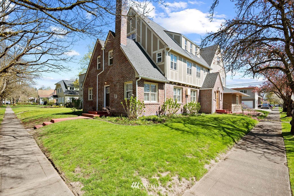 2030 Maple Street, Unit 16 Longview, WA 98632 - Photo 2 of 31 a view of a brick house with a big yard plants and large trees
