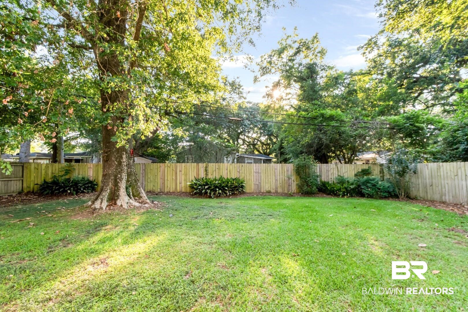 263 Border Drive East Mobile, AL 36608 - Photo 22 of 27 Expansive green lawn surrounded by a natural wood fence