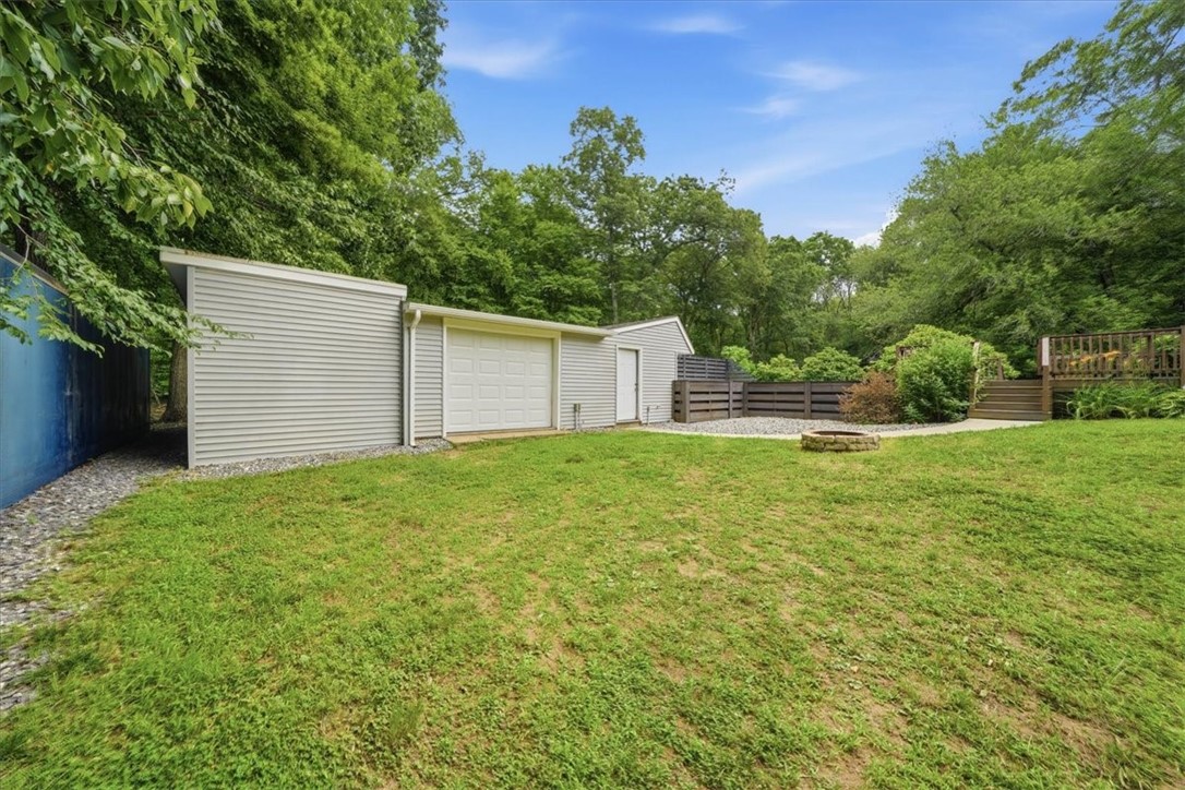 214 Anan Wade Road Glocester, RI 02857 - Photo 42 of 50 This detached structure is far more than a simple pool house—it offers multiple connected spaces with tremendous flexibility. This space could be ideal for a workshop or hobby space, motorcycle or recreational equipment storage, home gym, studio or creative workspace, additional household storage, future finished-space possibilities including In-Law or ADU. A 40-foot Connex offers tremendous additional storage capacity and may remain for the next owner.