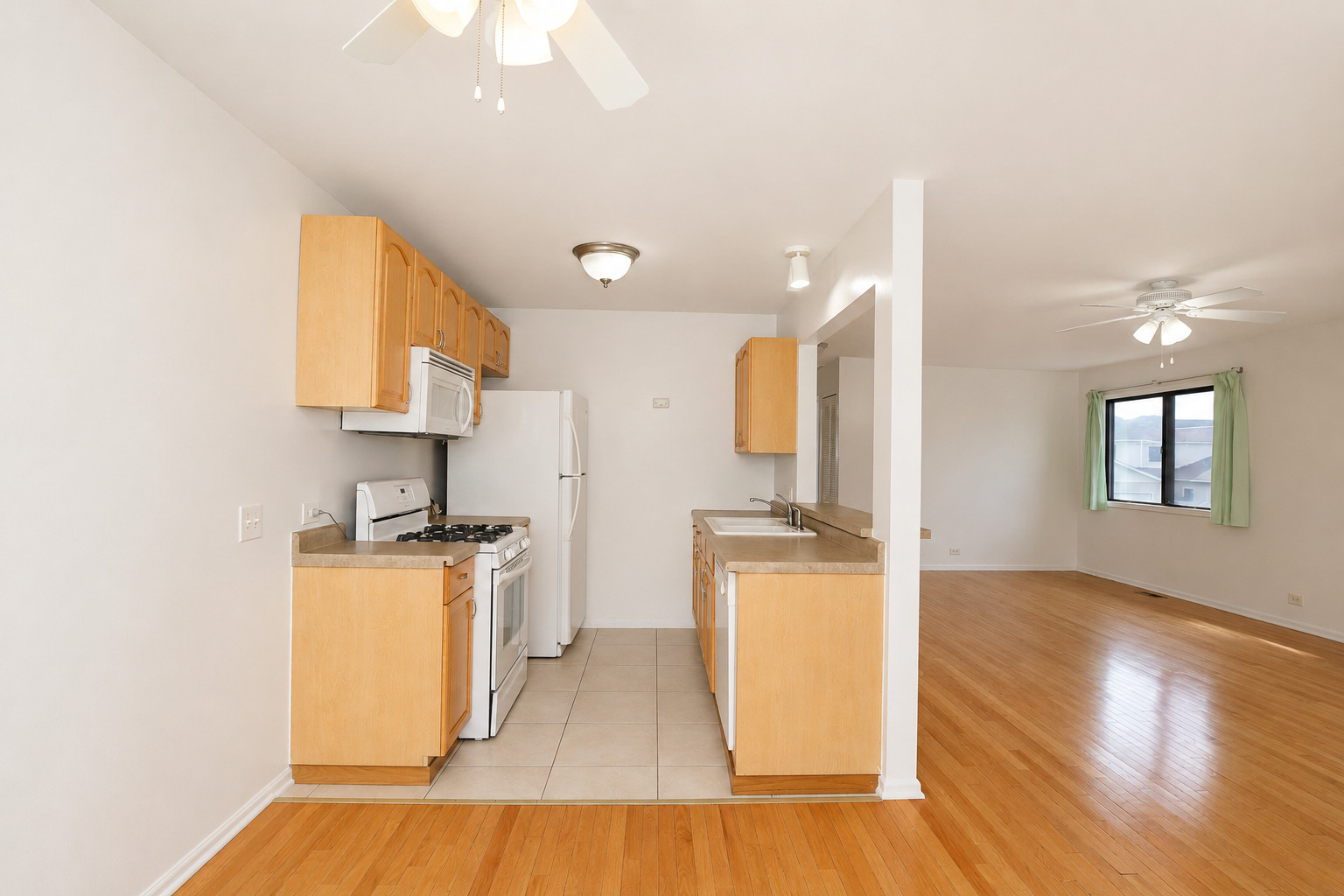 707 Sunfish Point, Unit 707 Schaumburg, IL 60194 - Photo 11 of 20 a kitchen with a sink appliances wooden floor and a window