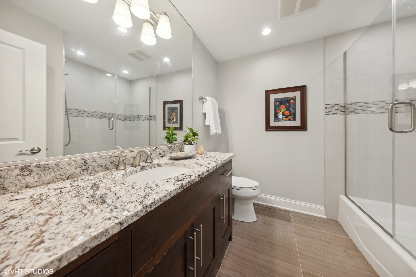 6 Bel Aire Court Burr Ridge, IL 60527 - Photo 13 of 37 a bathroom with a granite countertop sink a toilet and a shower