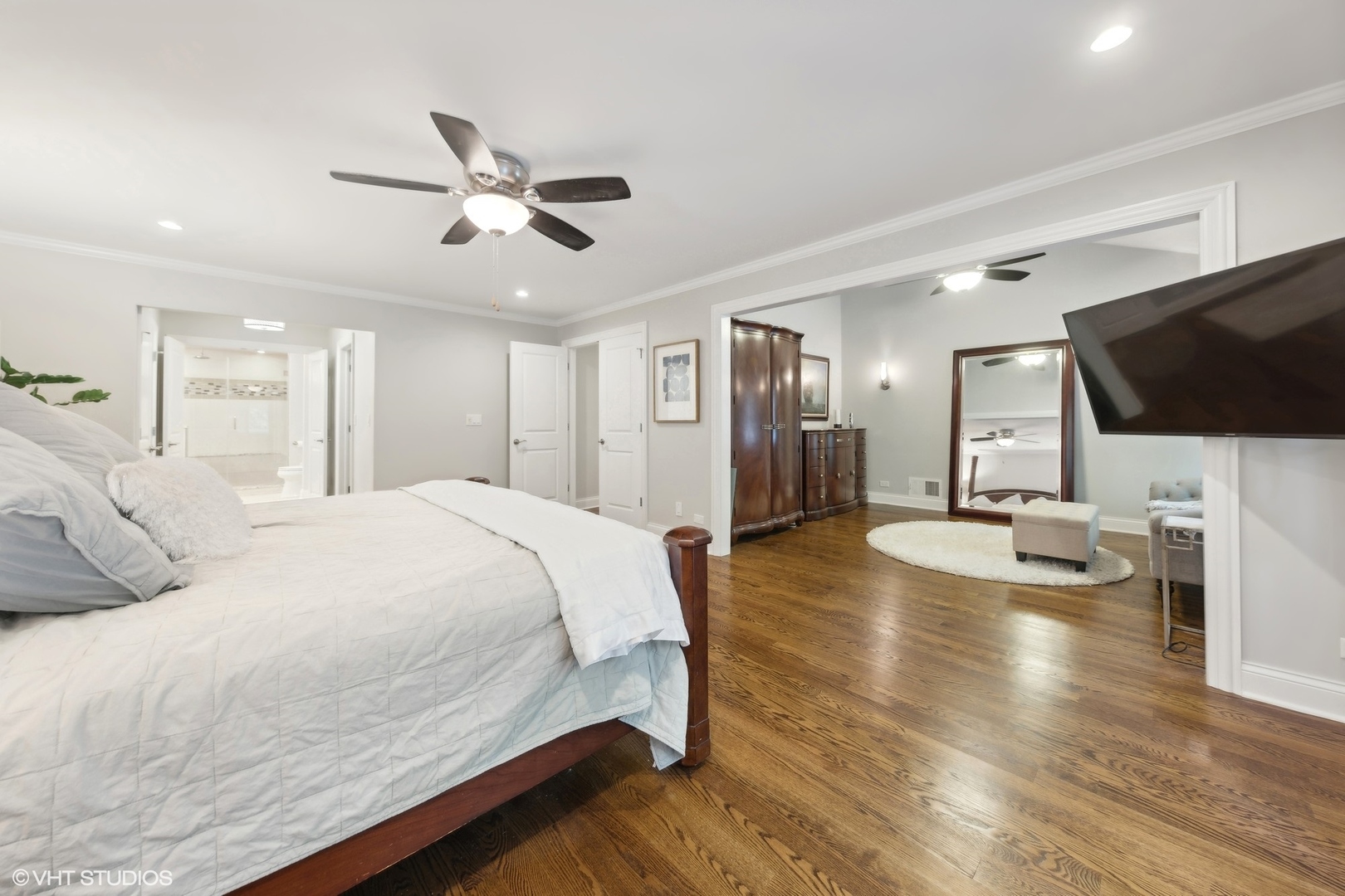 6 Bel Aire Court Burr Ridge, IL 60527 - Photo 15 of 37 a spacious bedroom with a bed a flat screen tv and a chandelier