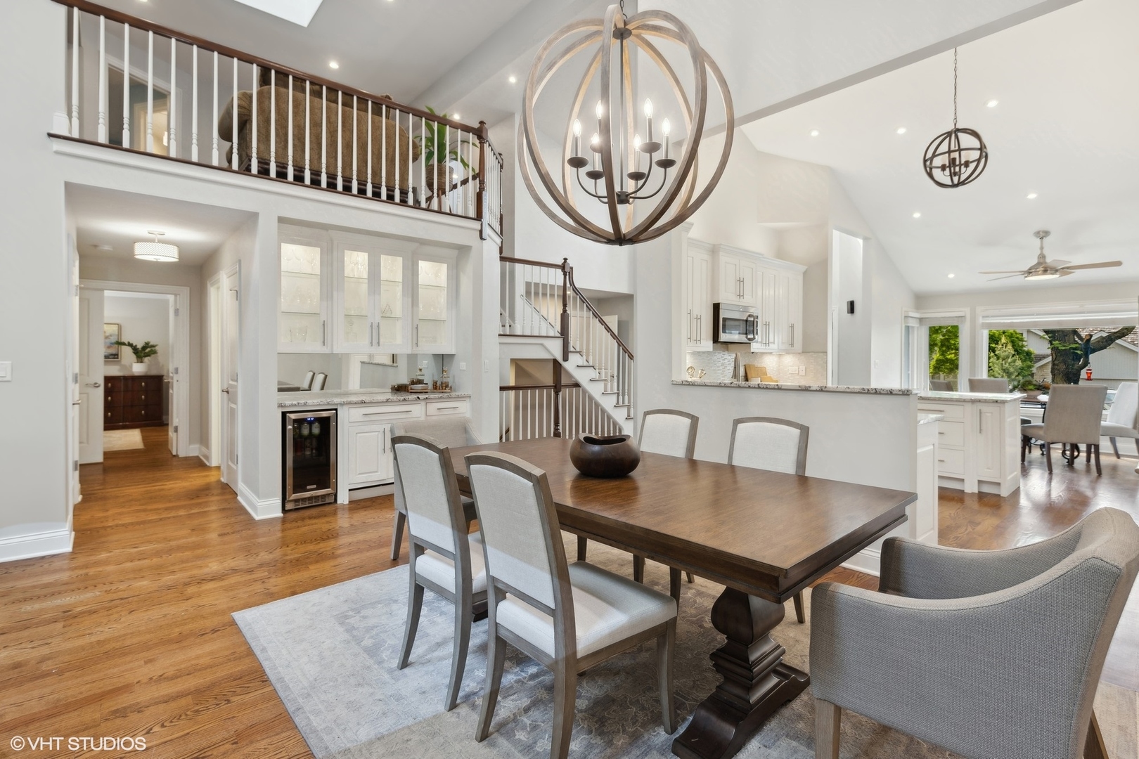 6 Bel Aire Court Burr Ridge, IL 60527 - Photo 9 of 37 a dining room with wooden floor a chandelier a wooden table and chairs