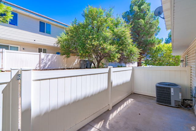 1735 West 540 North, Unit 1805 St. George, UT 84770 - Photo 30 of 64 Private patio with concrete flooring, white vinyl fencing, and a side gate