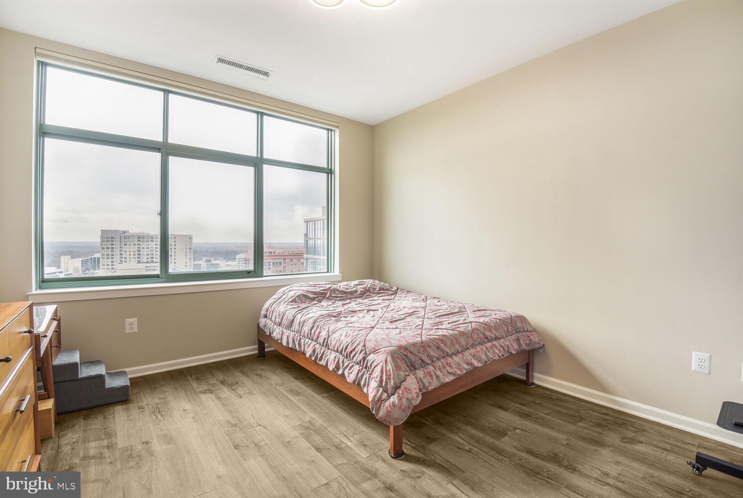 11700 Old Georgetown Road, Unit 1604 North Bethesda, MD 20852 - Photo 18 of 41 a bedroom with a bed and a large window
