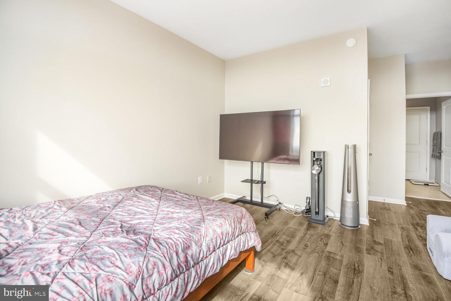 11700 Old Georgetown Road, Unit 1604 North Bethesda, MD 20852 - Photo 19 of 41 a bedroom with a bed and a flat screen tv