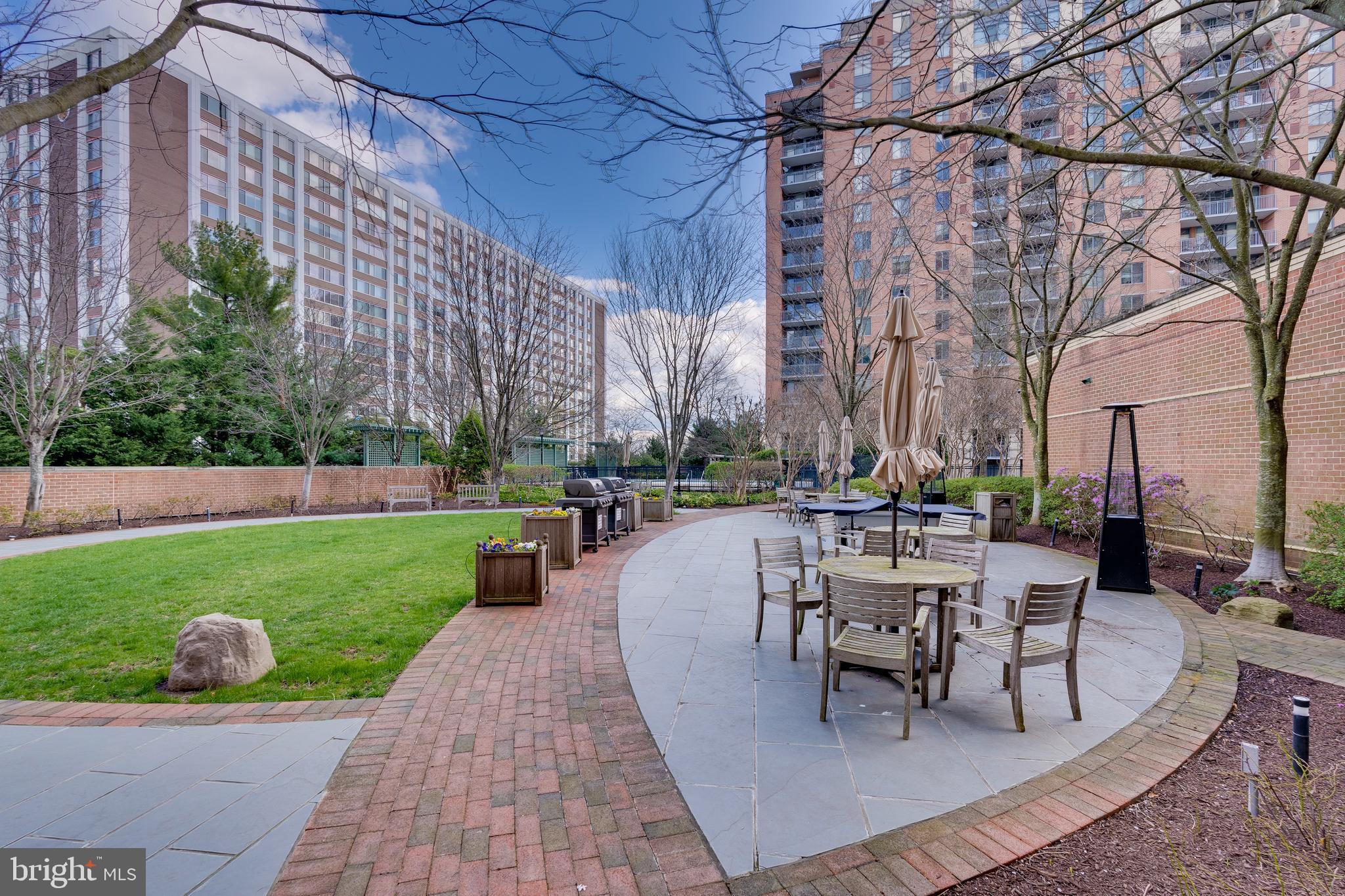 11700 Old Georgetown Road, Unit 1604 North Bethesda, MD 20852 - Photo 27 of 41 a swimming pool with outdoor seating and garden