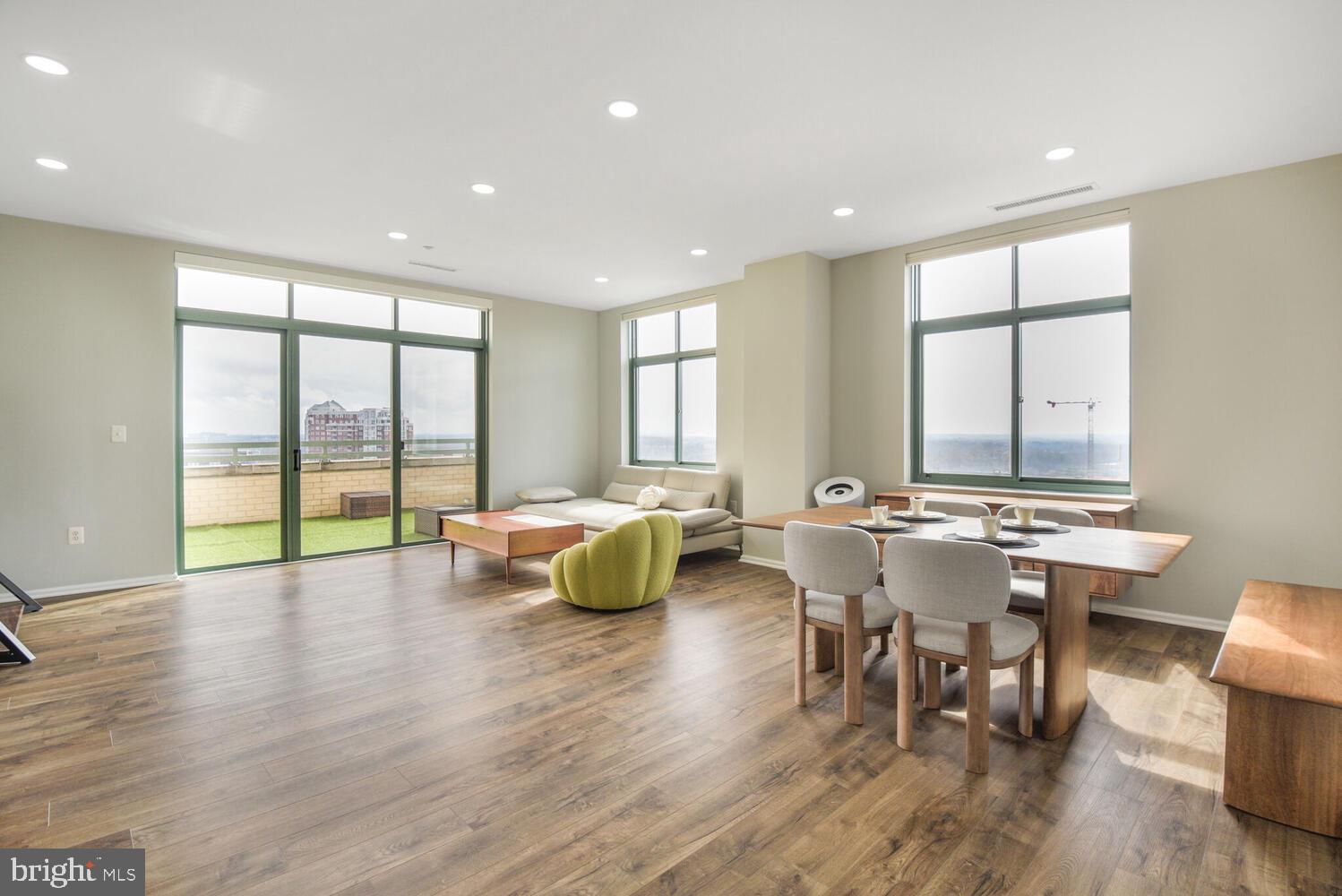 11700 Old Georgetown Road, Unit 1604 North Bethesda, MD 20852 - Photo 3 of 41 a large dining space with furniture window and wooden floor