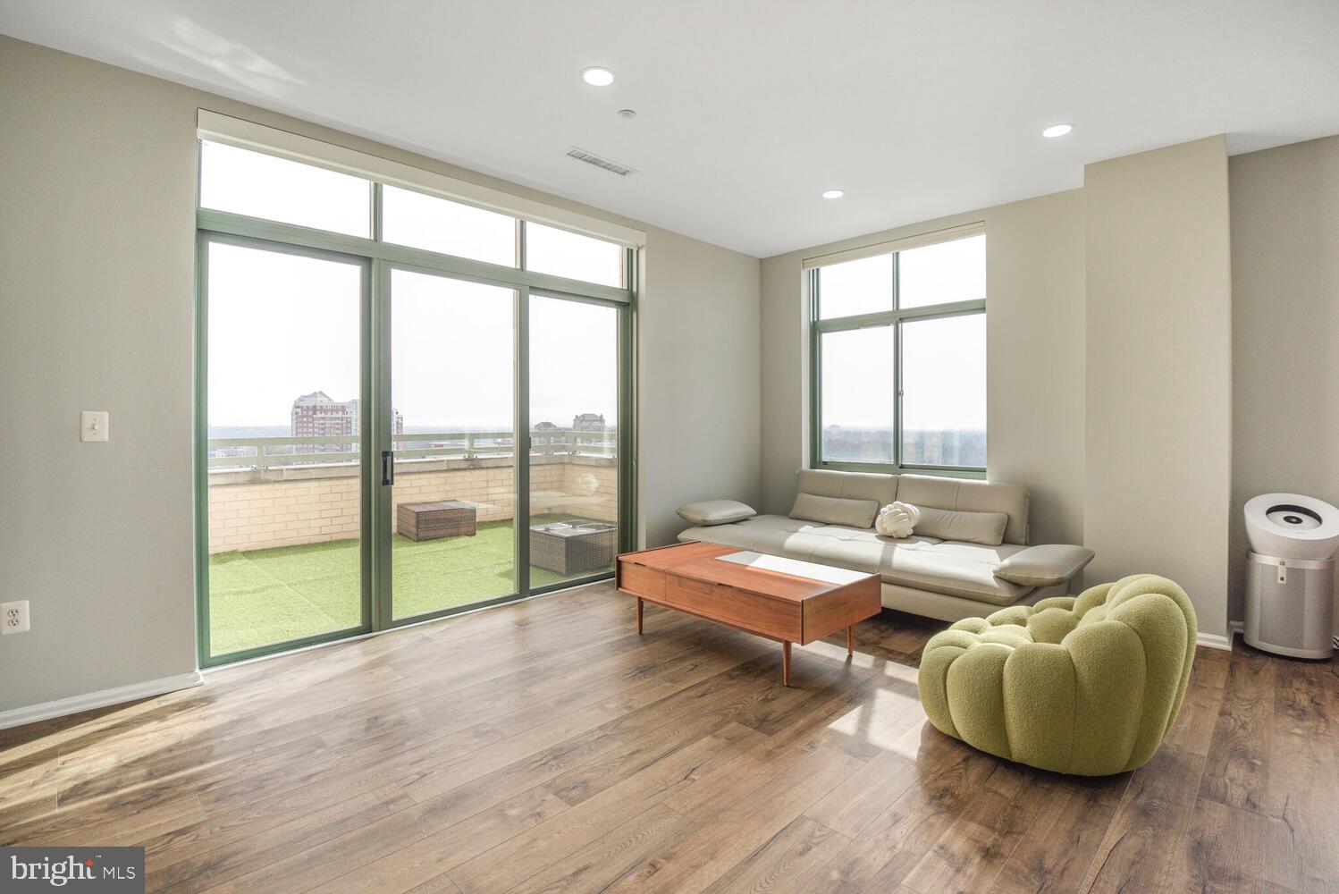 11700 Old Georgetown Road, Unit 1604 North Bethesda, MD 20852 - Photo 4 of 41 a living room with furniture and floor to ceiling windows