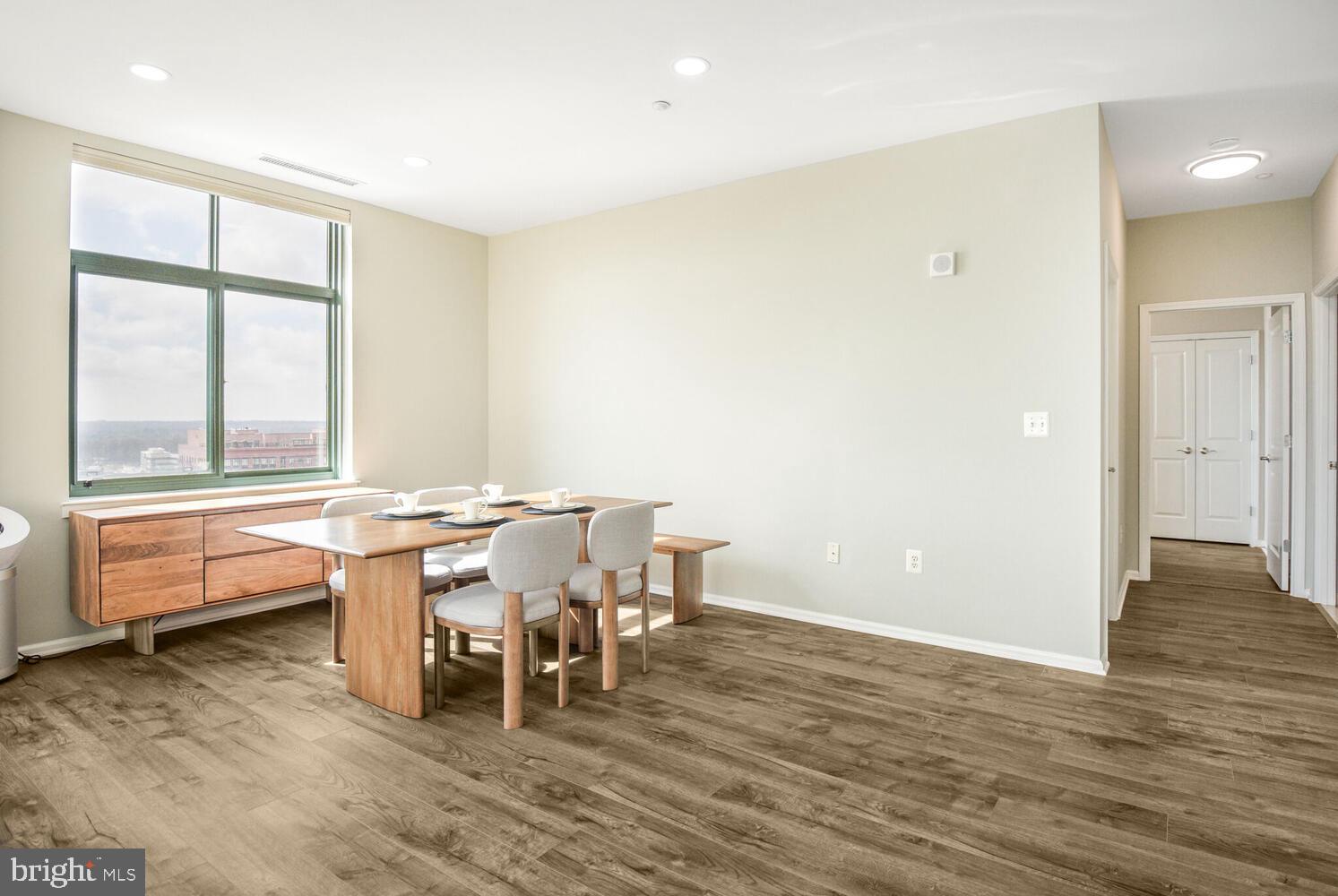 11700 Old Georgetown Road, Unit 1604 North Bethesda, MD 20852 - Photo 6 of 41 a dining room with a wooden table and chairs