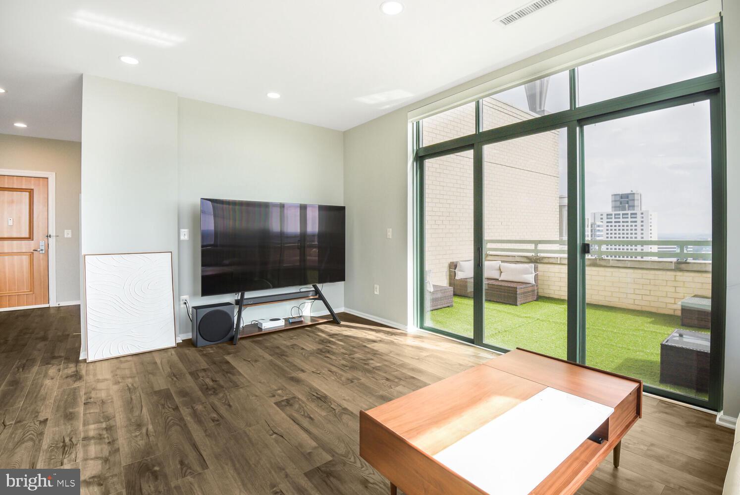 11700 Old Georgetown Road, Unit 1604 North Bethesda, MD 20852 - Photo 8 of 41 a room with furniture and a flat screen tv