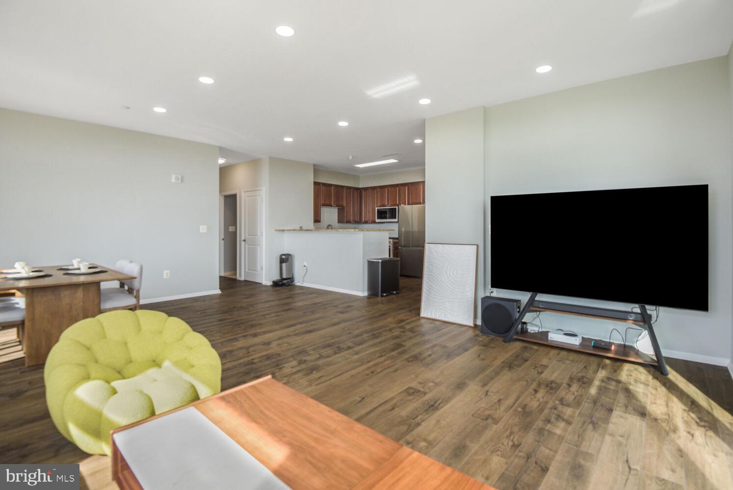 11700 Old Georgetown Road, Unit 1604 North Bethesda, MD 20852 - Photo 9 of 41 a living room with furniture and a flat screen tv