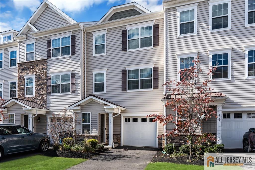 504 East International Road, Unit 504 Monroe Township, NJ 08831 - Photo 1 of 29 a front view of a house with a yard
