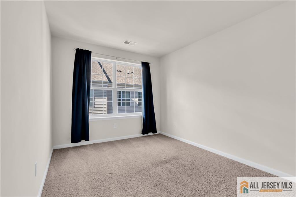 504 East International Road, Unit 504 Monroe Township, NJ 08831 - Photo 18 of 29 a view of an empty room with a window
