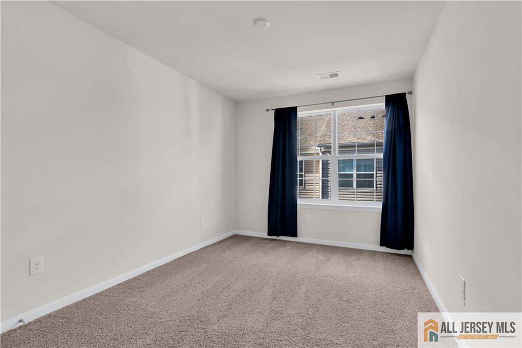 504 East International Road, Unit 504 Monroe Township, NJ 08831 - Photo 19 of 29 a view of an empty room with a window