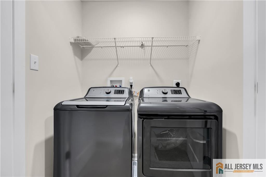 504 East International Road, Unit 504 Monroe Township, NJ 08831 - Photo 22 of 29 a utility room with dryer and washer