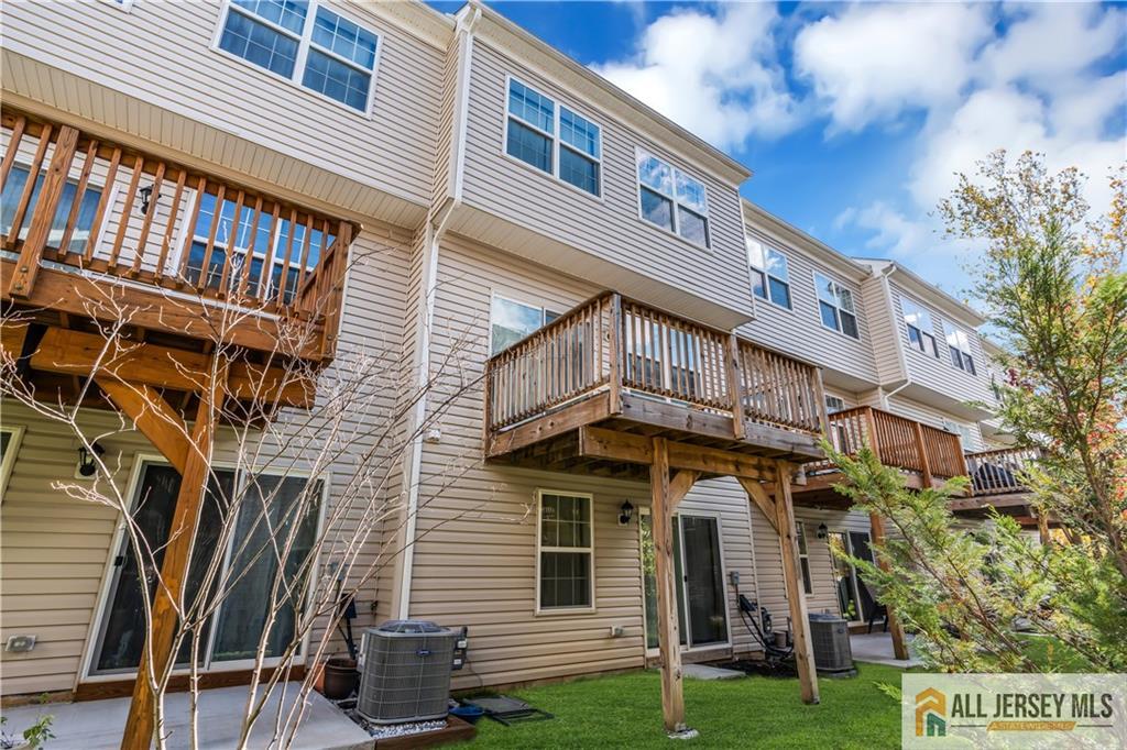 504 East International Road, Unit 504 Monroe Township, NJ 08831 - Photo 28 of 29 a front view of a building with garden