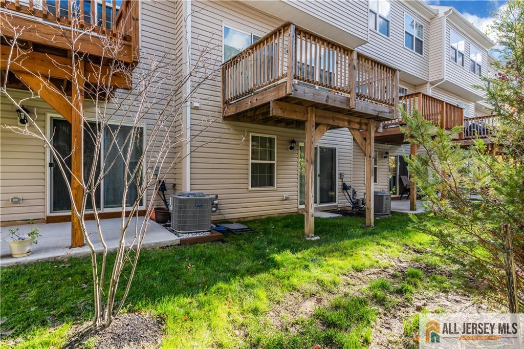504 East International Road, Unit 504 Monroe Township, NJ 08831 - Photo 29 of 29 a view of a house with a yard and sitting area