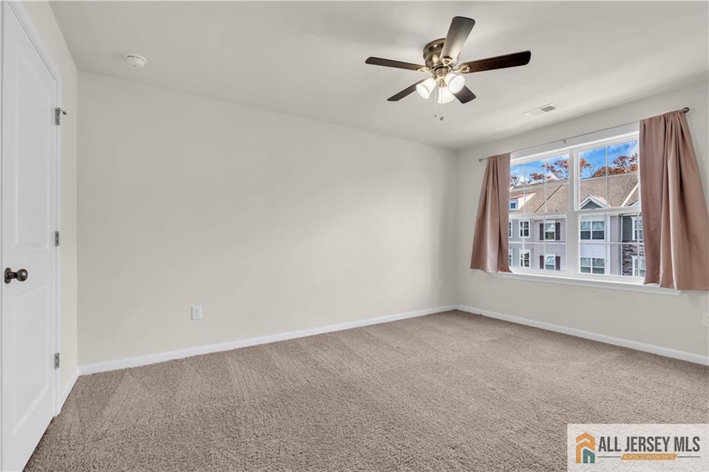 504 East International Road, Unit 504 Monroe Township, NJ 08831 - Photo 6 of 29 a view of an empty room with a window