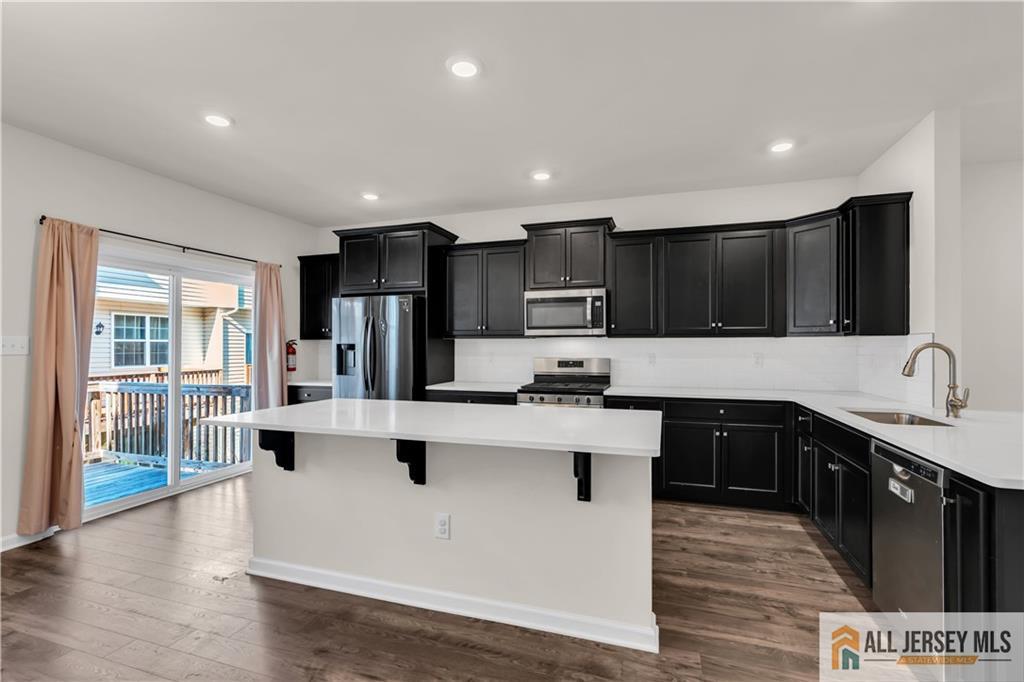 504 East International Road, Unit 504 Monroe Township, NJ 08831 - Photo 8 of 29 a kitchen with stainless steel appliances granite countertop a sink stove and refrigerator