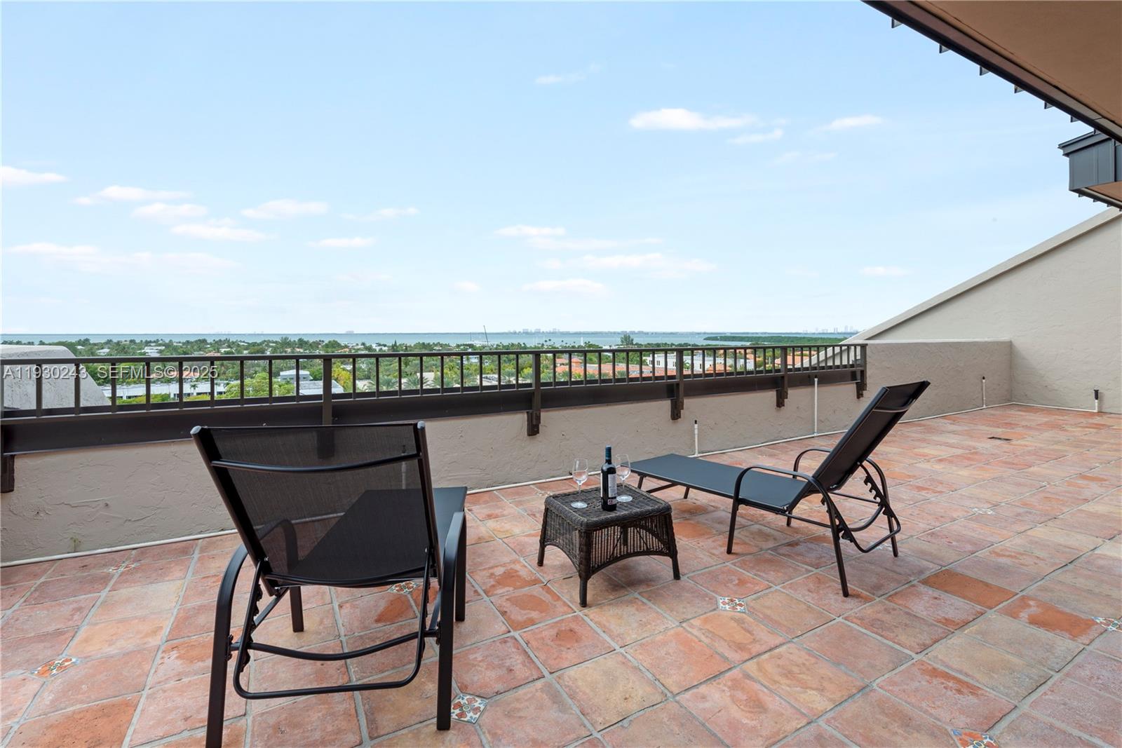 a roof deck with table and chairs