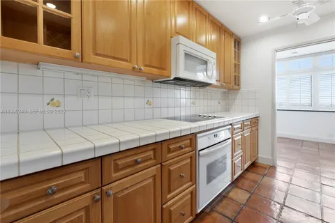 a kitchen with stainless steel appliances granite countertop a sink and a stove