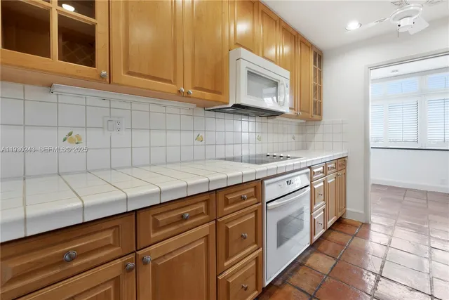 a kitchen with stainless steel appliances granite countertop a sink and a stove