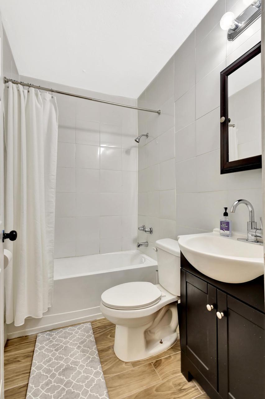 1075 West 30th Street Riviera Beach, FL 33404 - Photo 11 of 66 a bathroom with a sink toilet a mirror and shower