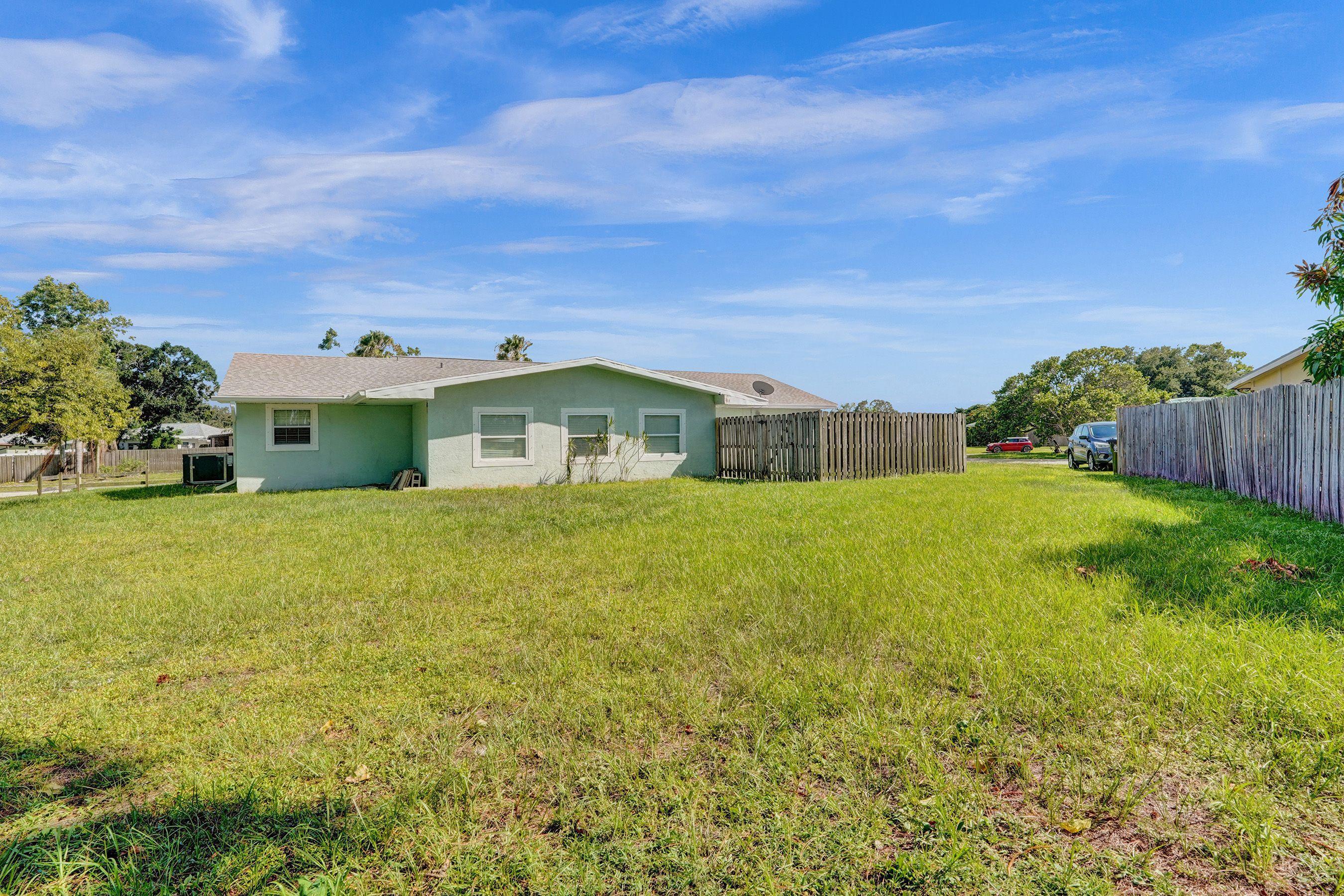 1075 West 30th Street Riviera Beach, FL 33404 - Photo 15 of 66 a front view of a house with garden