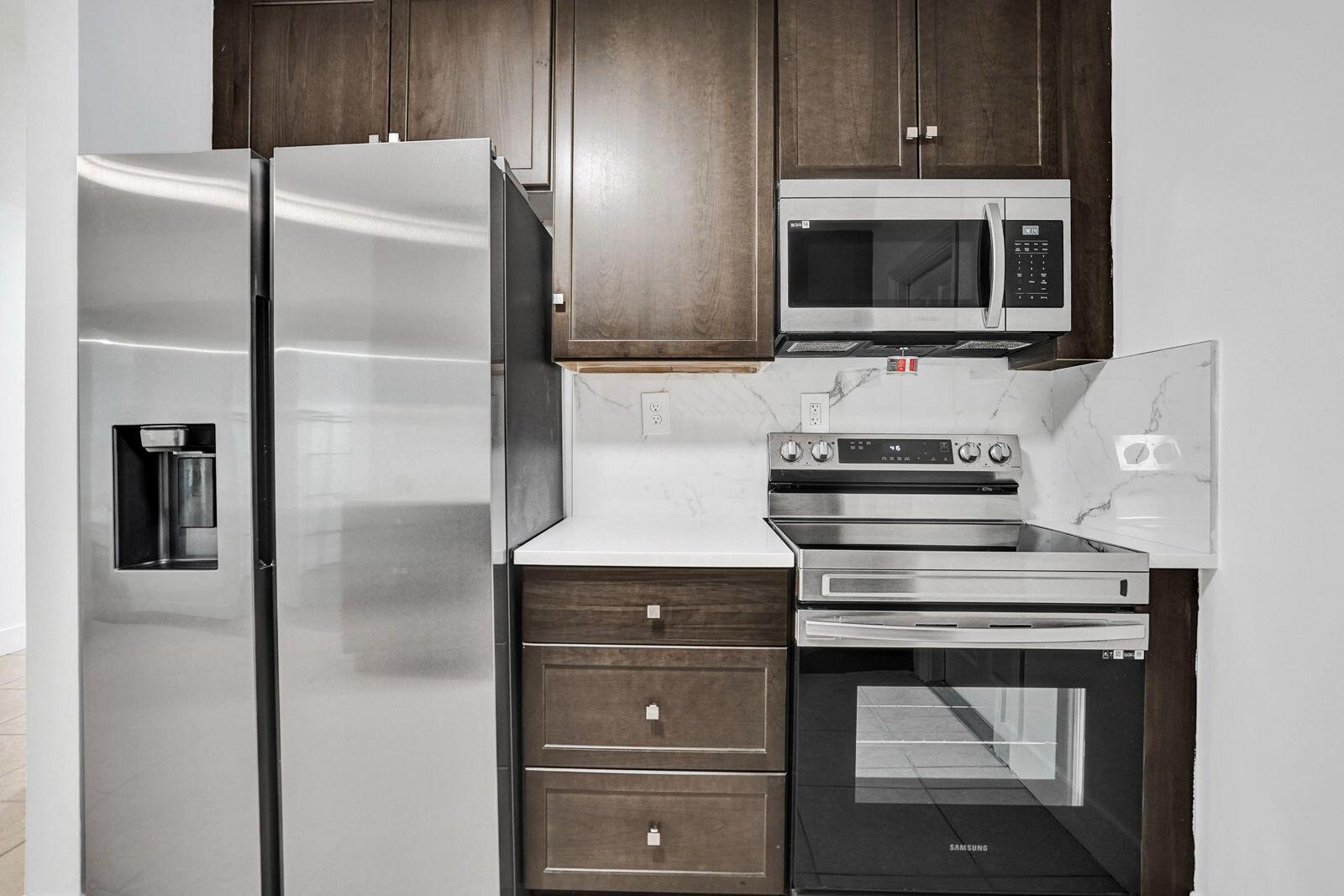 1075 West 30th Street Riviera Beach, FL 33404 - Photo 16 of 66 a kitchen with cabinets and stainless steel appliances