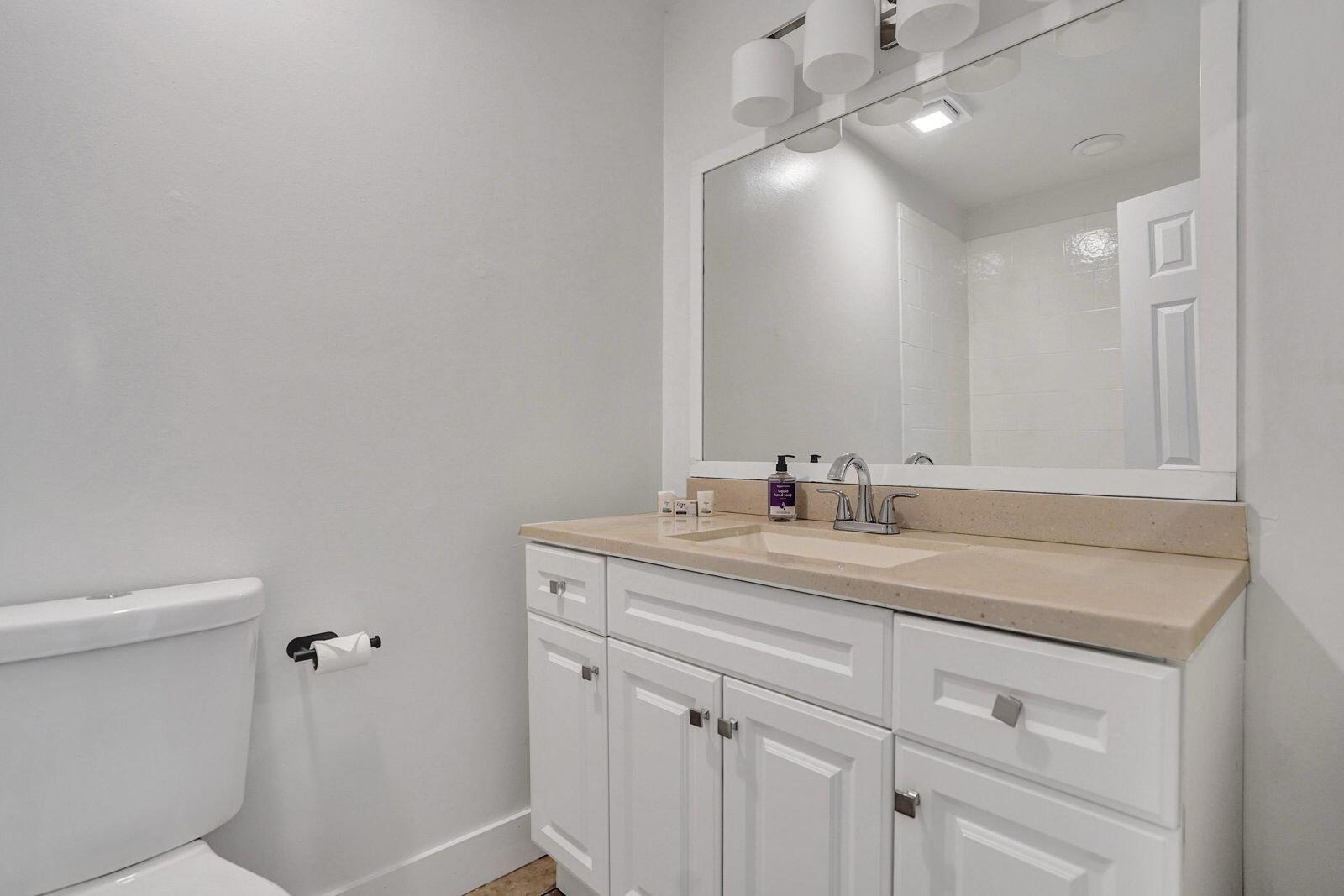 1075 West 30th Street Riviera Beach, FL 33404 - Photo 24 of 66 a bathroom with a sink vanity and a toilet