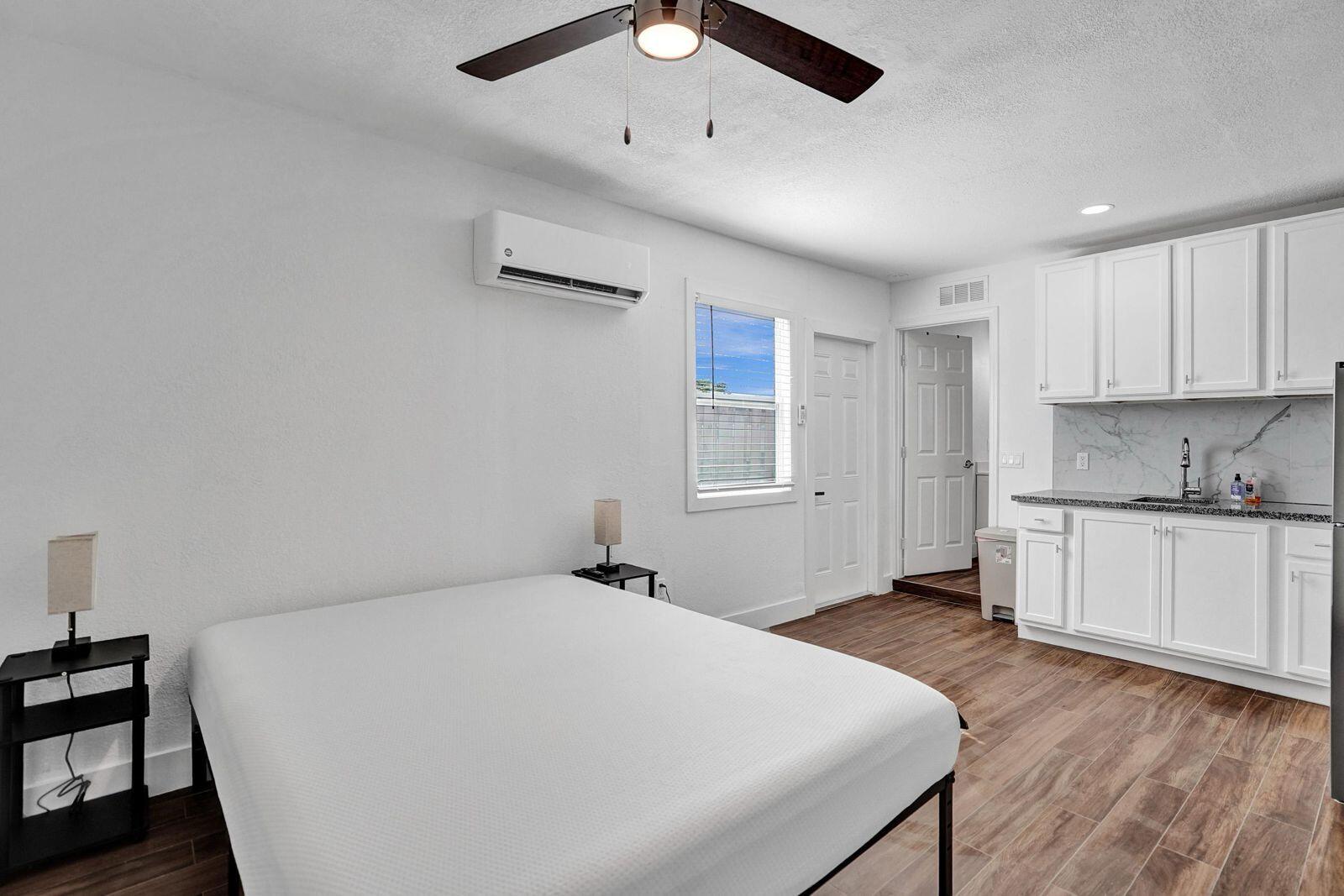 1075 West 30th Street Riviera Beach, FL 33404 - Photo 27 of 66 a spacious bedroom with a bed and a window