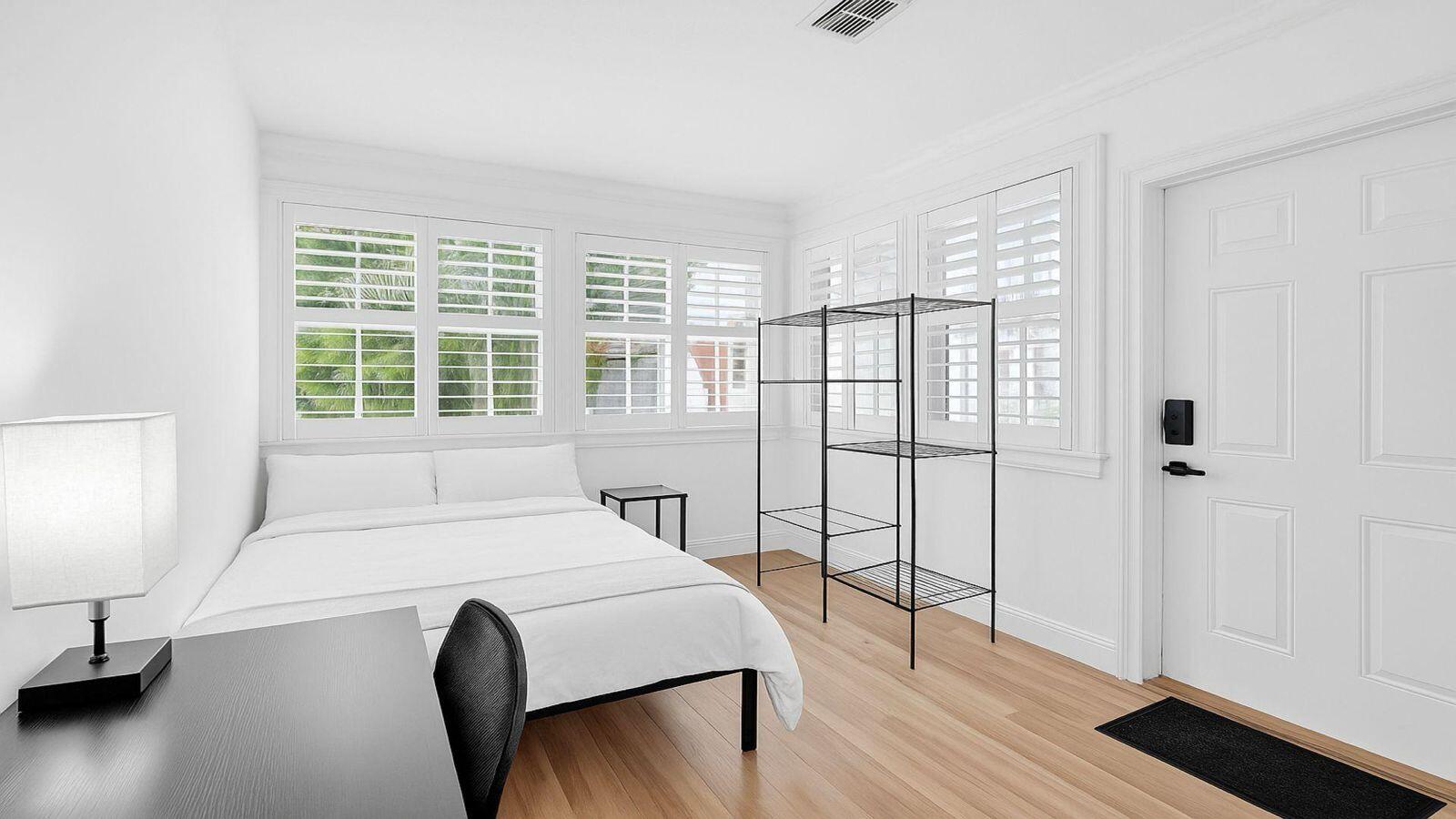 1075 West 30th Street Riviera Beach, FL 33404 - Photo 37 of 66 a bedroom with a bed and a large window